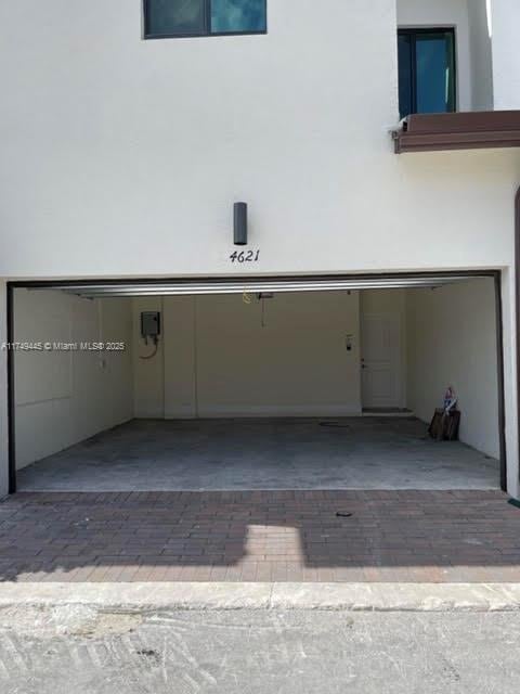 garage featuring decorative driveway