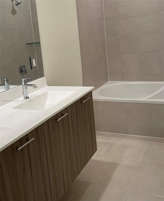 bathroom featuring tiled shower / bath combo, vanity, and tile patterned floors