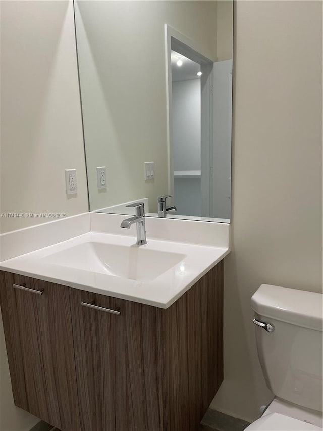 bathroom featuring toilet and vanity