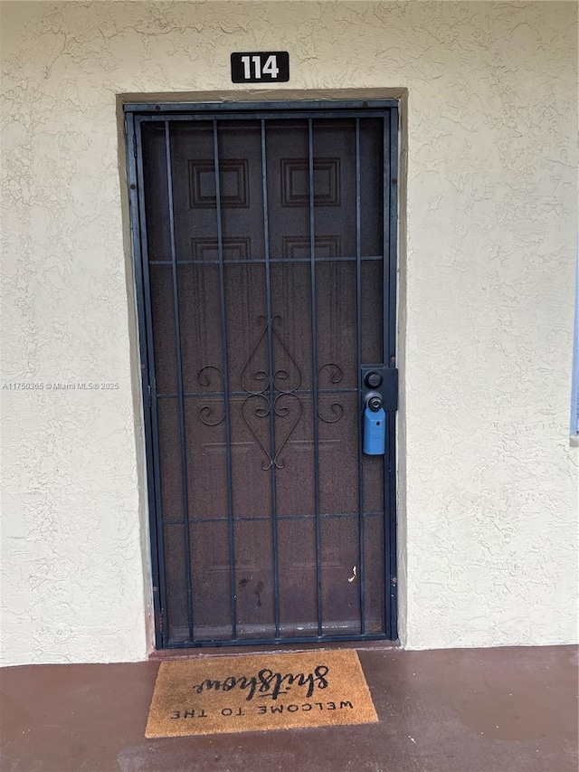 entrance to property with stucco siding