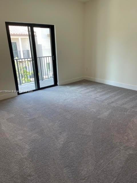 spare room with carpet floors and baseboards