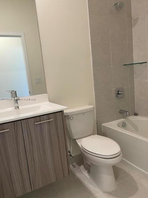 bathroom featuring vanity, shower / bathing tub combination, tile patterned flooring, and toilet