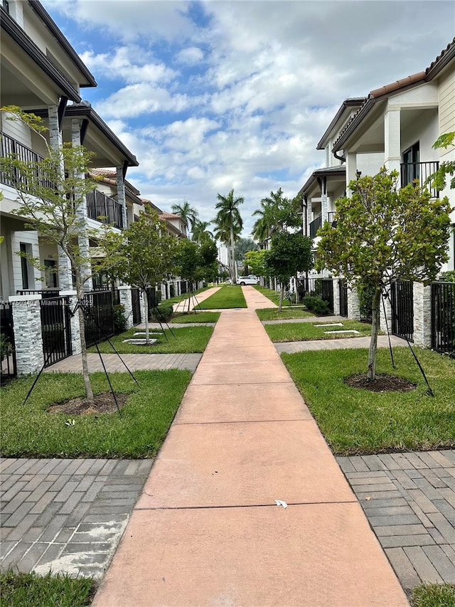 view of community featuring a yard and fence