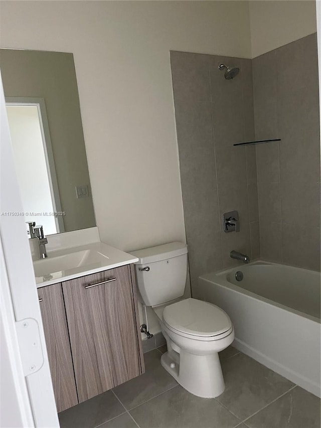 bathroom featuring tile patterned flooring, vanity, toilet, and shower / bathtub combination