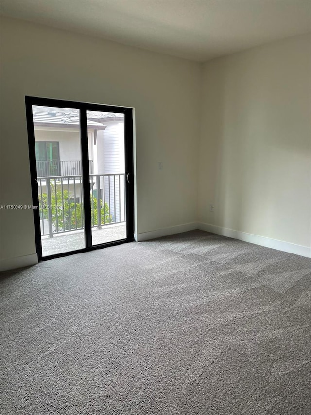 carpeted spare room with baseboards