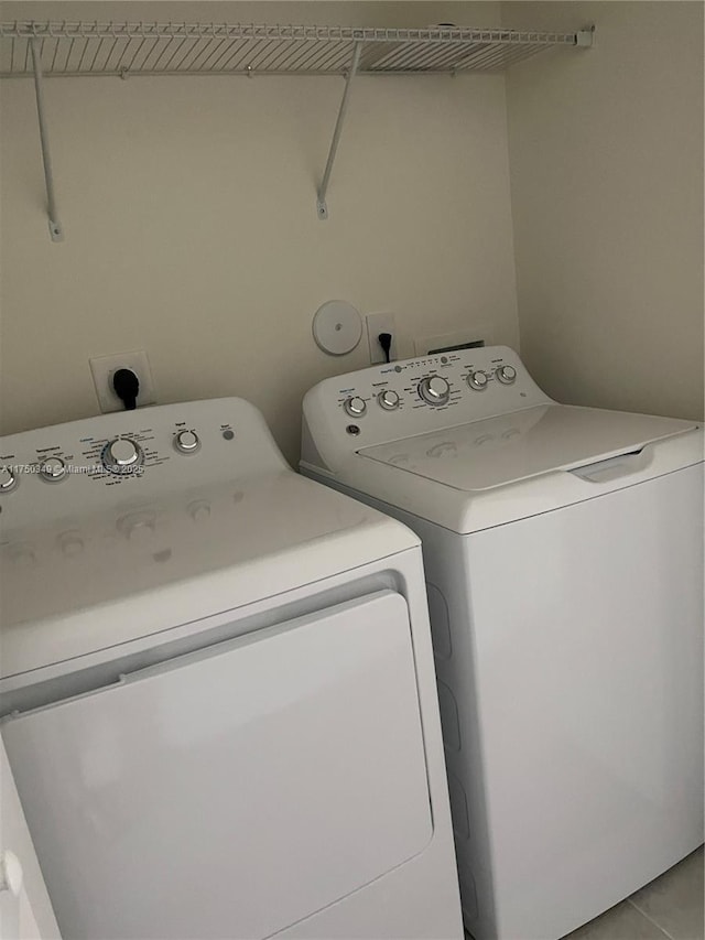 clothes washing area with washer and dryer and laundry area