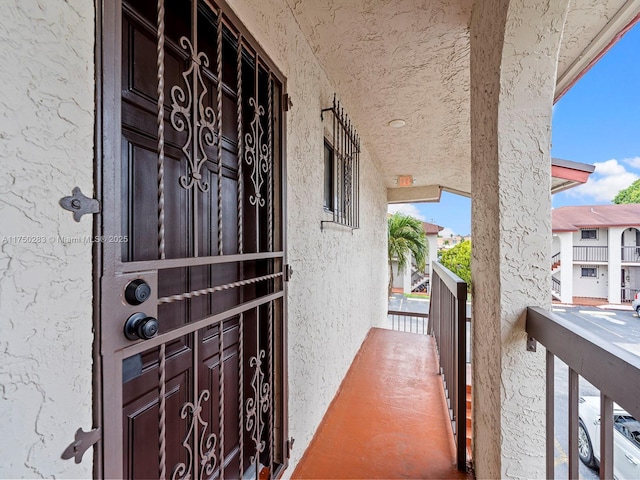 entrance to property featuring stucco siding