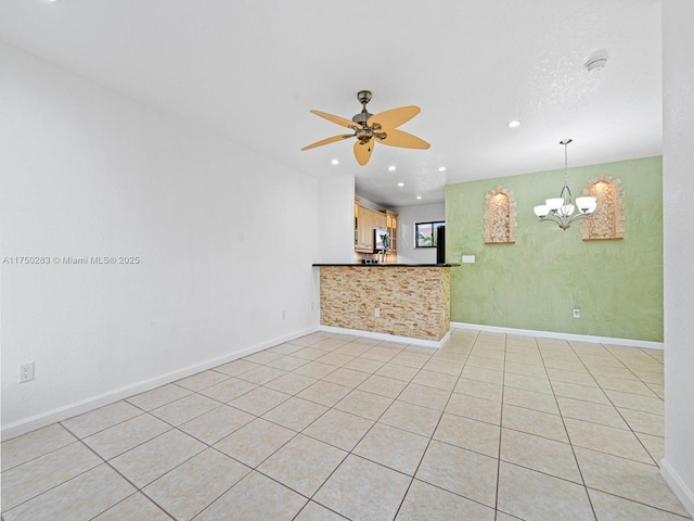 unfurnished room with recessed lighting, baseboards, and ceiling fan with notable chandelier