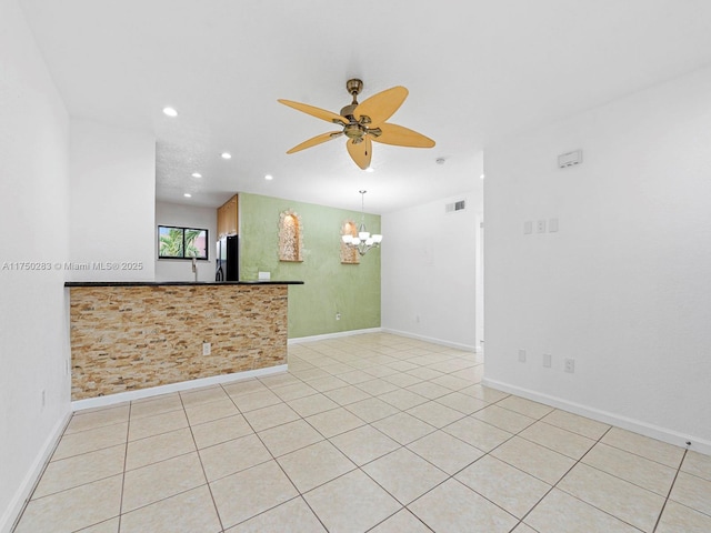 unfurnished room featuring light tile patterned floors, recessed lighting, ceiling fan with notable chandelier, visible vents, and baseboards