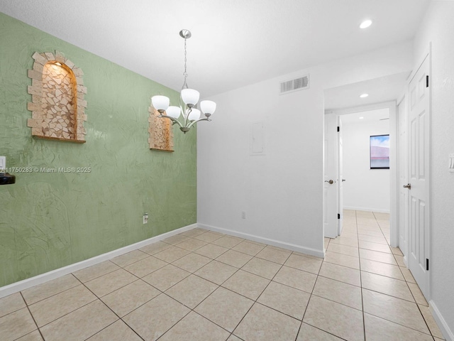 empty room featuring a chandelier, light tile patterned flooring, recessed lighting, visible vents, and baseboards