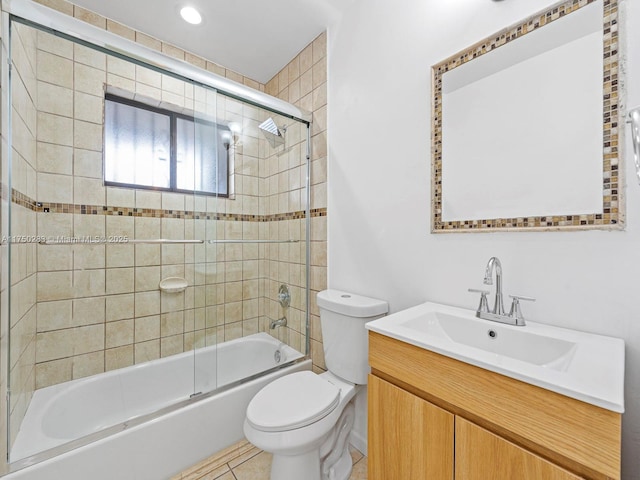 full bathroom featuring toilet, tile patterned floors, bath / shower combo with glass door, and vanity