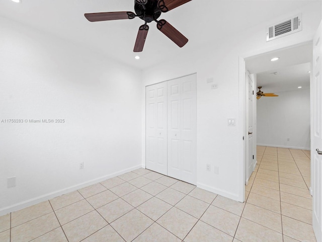 unfurnished bedroom with light tile patterned floors, recessed lighting, visible vents, baseboards, and a closet