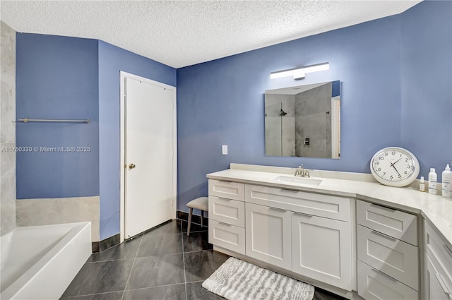 full bathroom featuring a textured ceiling, vanity, a bath, tile patterned floors, and walk in shower