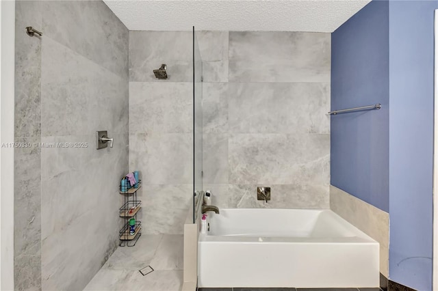 full bathroom featuring a textured ceiling and a bath