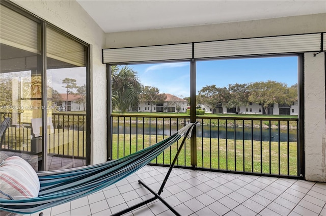 sunroom / solarium featuring plenty of natural light and a residential view