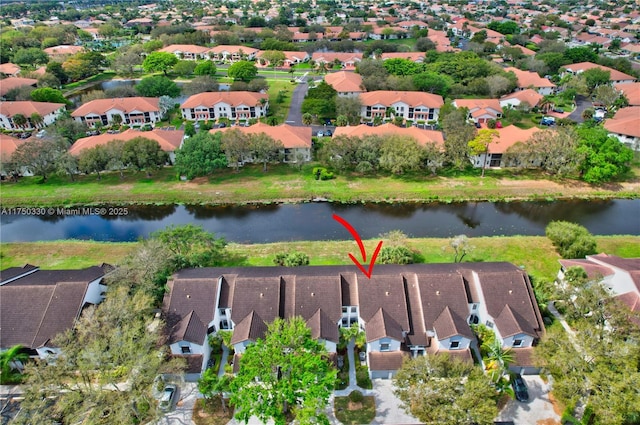 drone / aerial view featuring a residential view and a water view