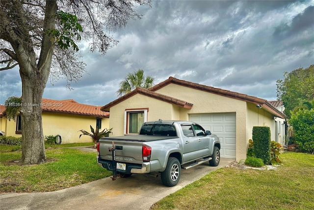 view of property exterior with a garage, a tiled roof, a lawn, and stucco siding