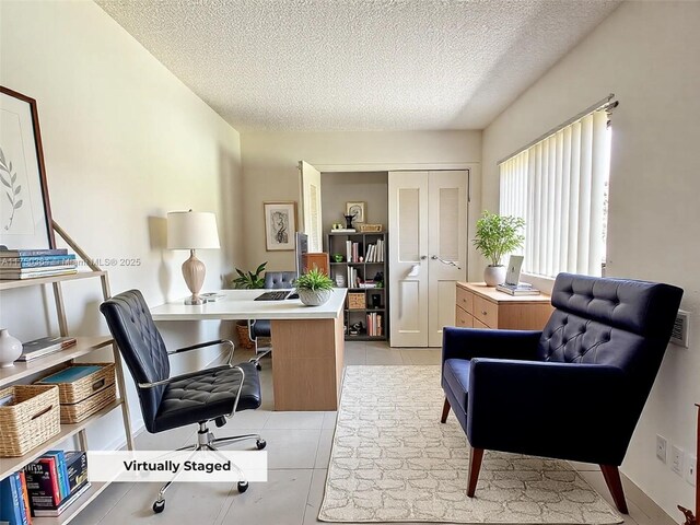 office featuring a textured ceiling, visible vents, and light tile patterned floors