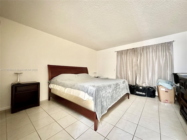 tiled bedroom featuring a textured ceiling