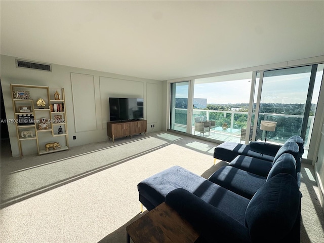 living room featuring carpet, expansive windows, and visible vents