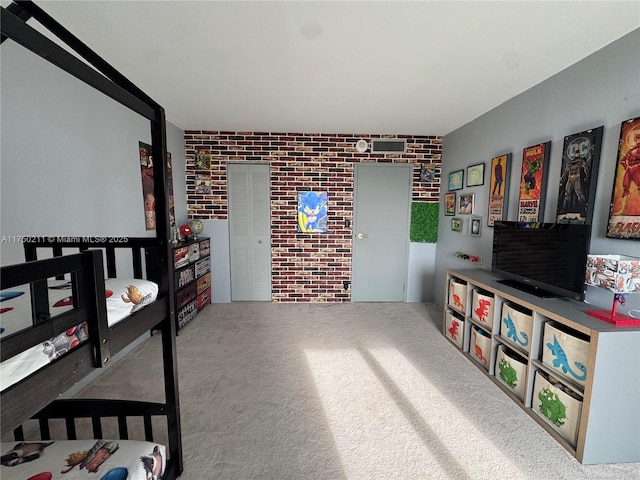 interior space with brick wall and carpet flooring