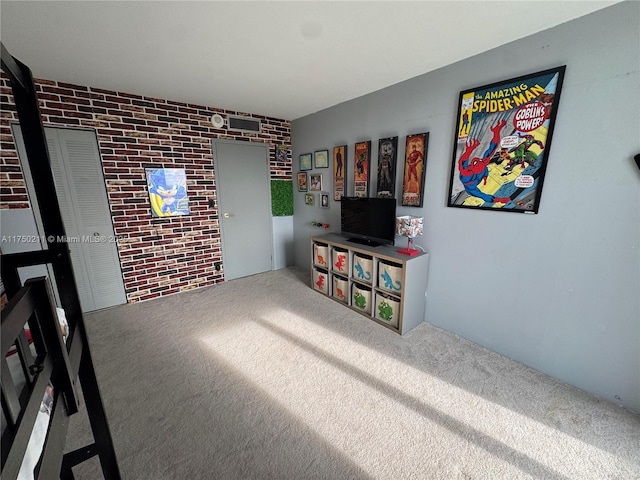 interior space with carpet floors and brick wall