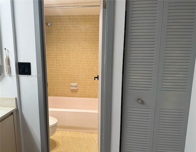 bathroom featuring shower / bathtub combination, a closet, toilet, vanity, and tile patterned flooring