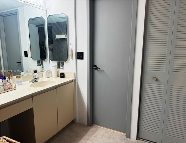 bathroom with a closet and vanity