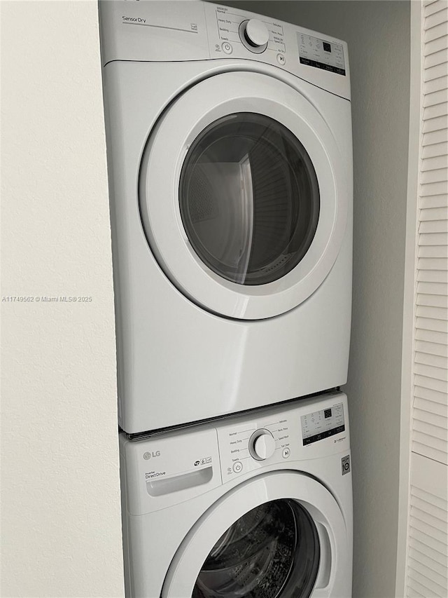 laundry area featuring stacked washing maching and dryer