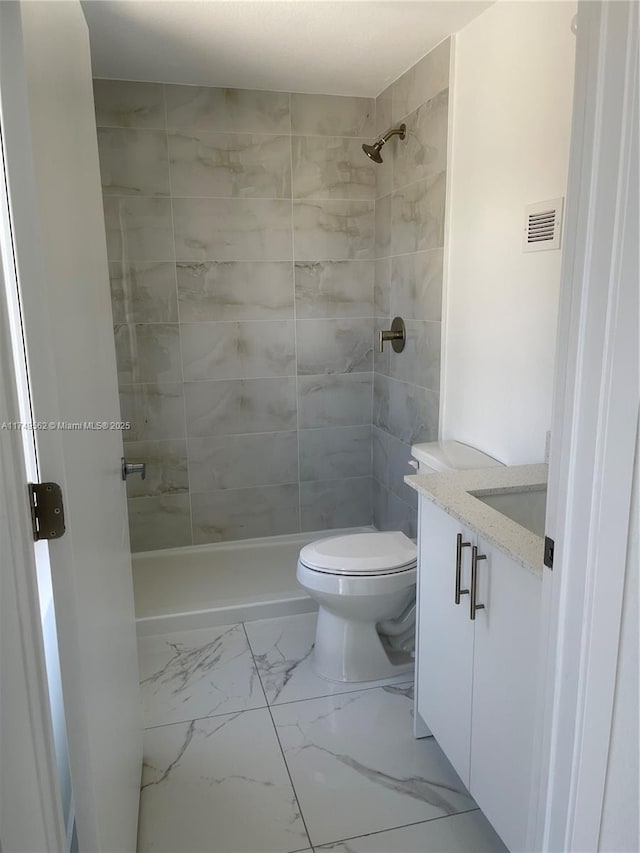 bathroom with a stall shower, visible vents, toilet, marble finish floor, and vanity