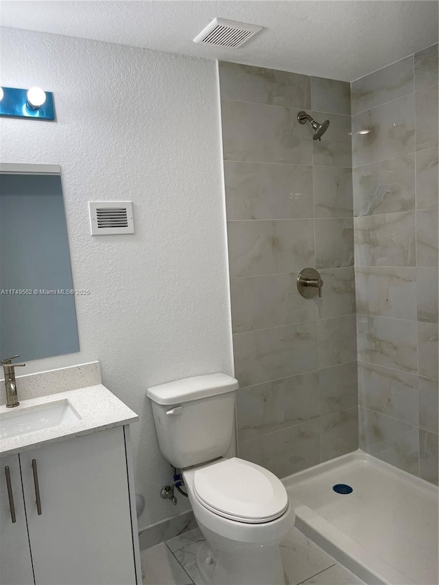 bathroom featuring toilet, marble finish floor, visible vents, and vanity