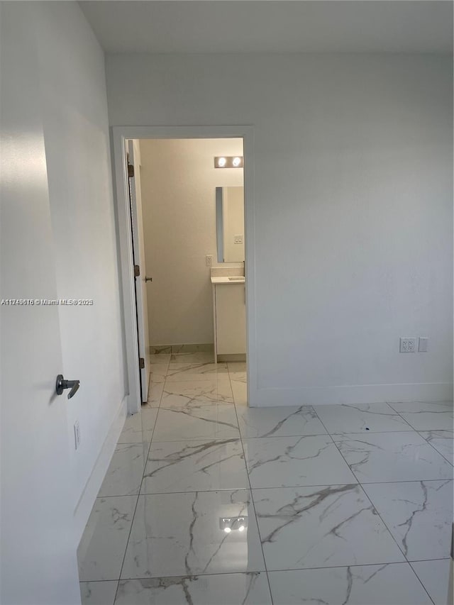 interior space with marble finish floor and baseboards