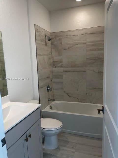 full bath with vanity, shower / tub combination, and toilet