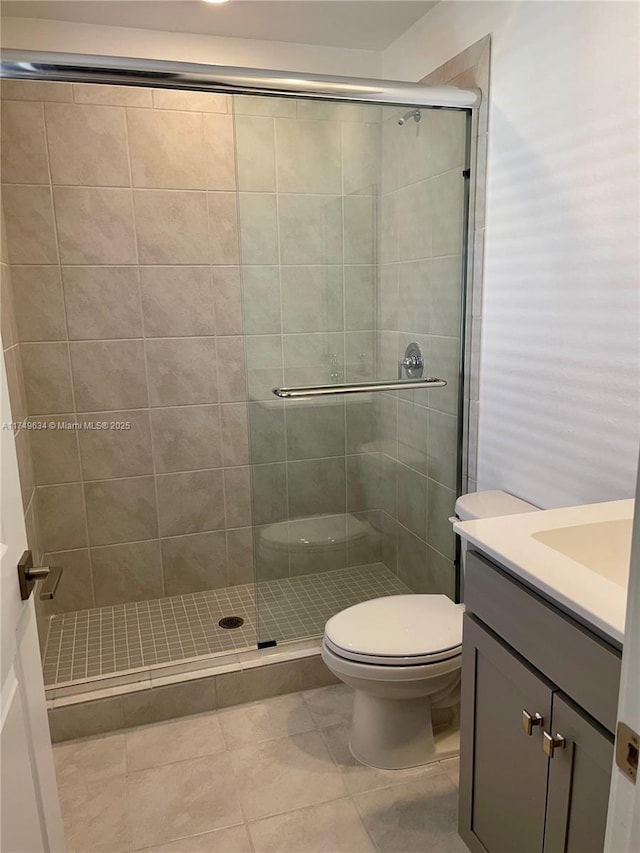 2435 SE 11th St, Homestead, FL 33035 - bathroom featuring tile patterned floors, vanity, toilet, and a shower stall