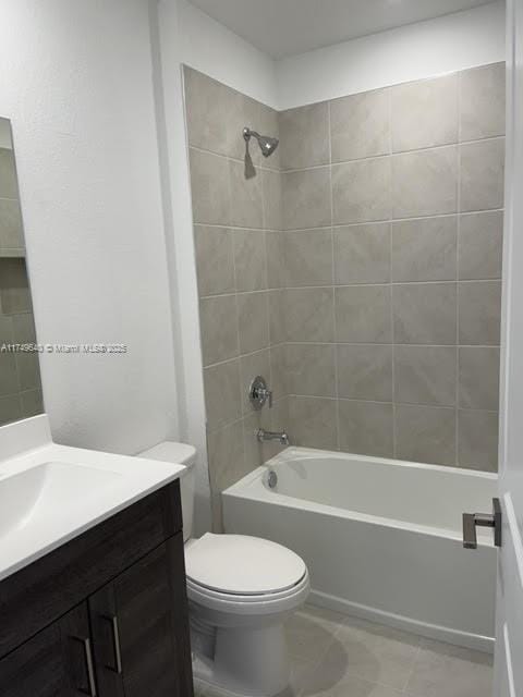 full bathroom featuring toilet, tile patterned flooring, shower / tub combination, and vanity