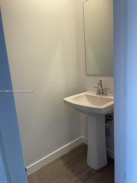 bathroom featuring baseboards and wood finished floors