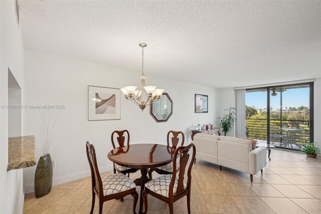 dining room with an inviting chandelier, light tile patterned floors, baseboards, and a textured ceiling
