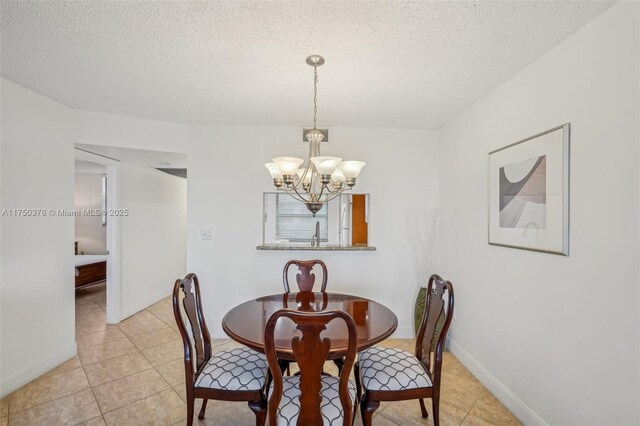 dining room featuring a textured ceiling, a notable chandelier, and light tile patterned floors