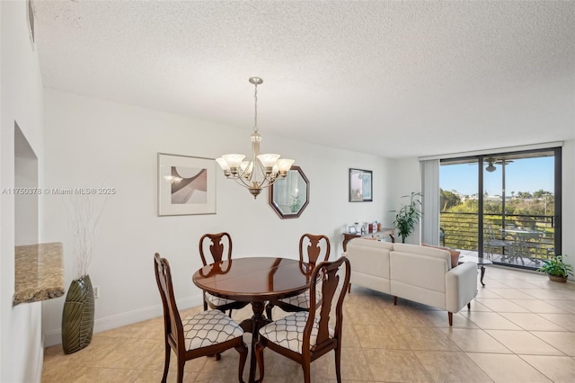 900 Colony Point Cir Unit 408, Pembroke Pines, FL 33026 - dining space with a chandelier, a textured ceiling, light tile patterned floors, and baseboards
