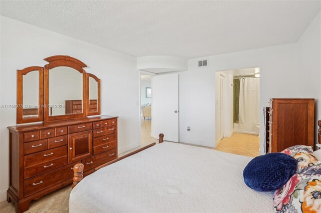 bedroom featuring connected bathroom and visible vents