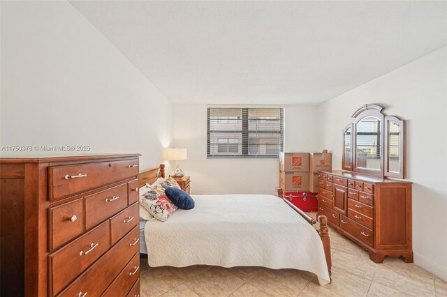 bedroom with light tile patterned floors