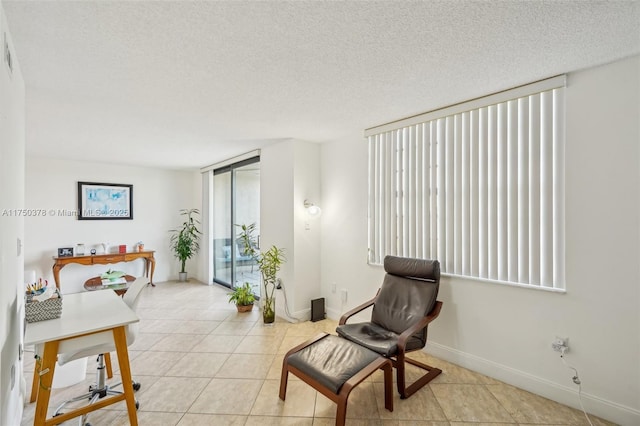 900 Colony Point Cir Unit 408, Pembroke Pines, FL 33026 - living area with an office area, light tile patterned flooring, a textured ceiling, baseboards, and floor to ceiling windows