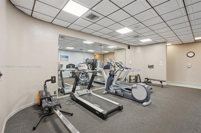 gym featuring baseboards, visible vents, and a drop ceiling