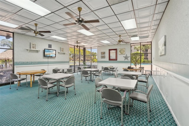 dining room featuring carpet flooring, ceiling fan, and baseboards