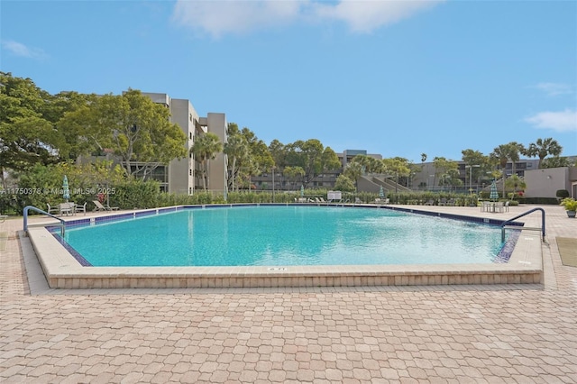 pool featuring a patio and fence