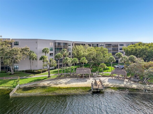 surrounding community with a water view and a gazebo