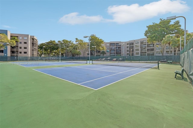 view of tennis court featuring fence