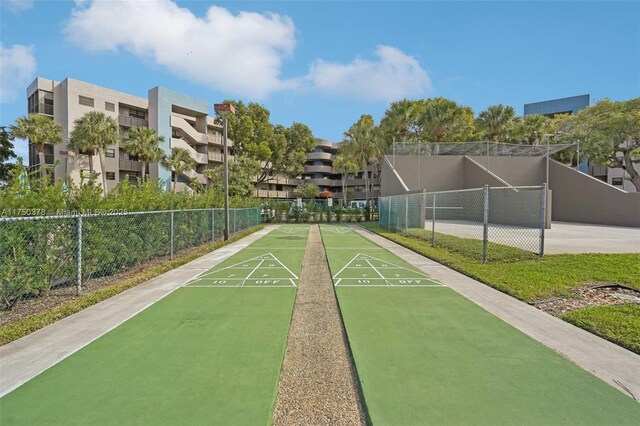 surrounding community with fence and shuffleboard