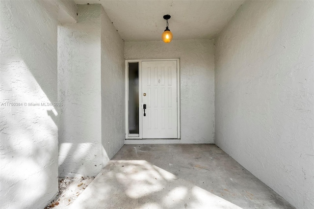 doorway to property featuring stucco siding