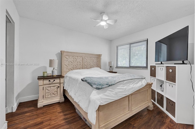 bedroom featuring dark wood-style floors, ceiling fan, baseboards, and a textured ceiling